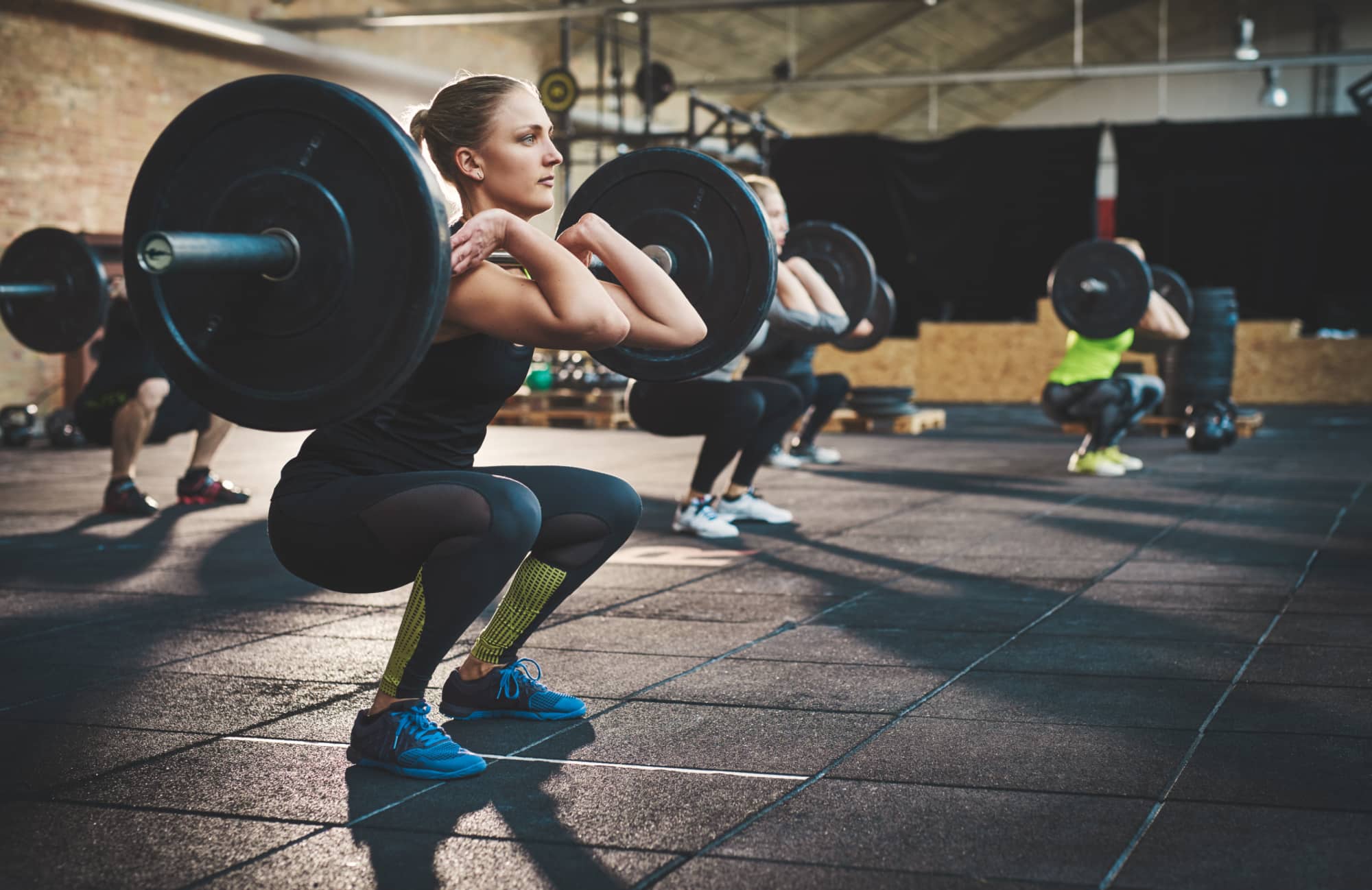 athletes lifting weights in the gym